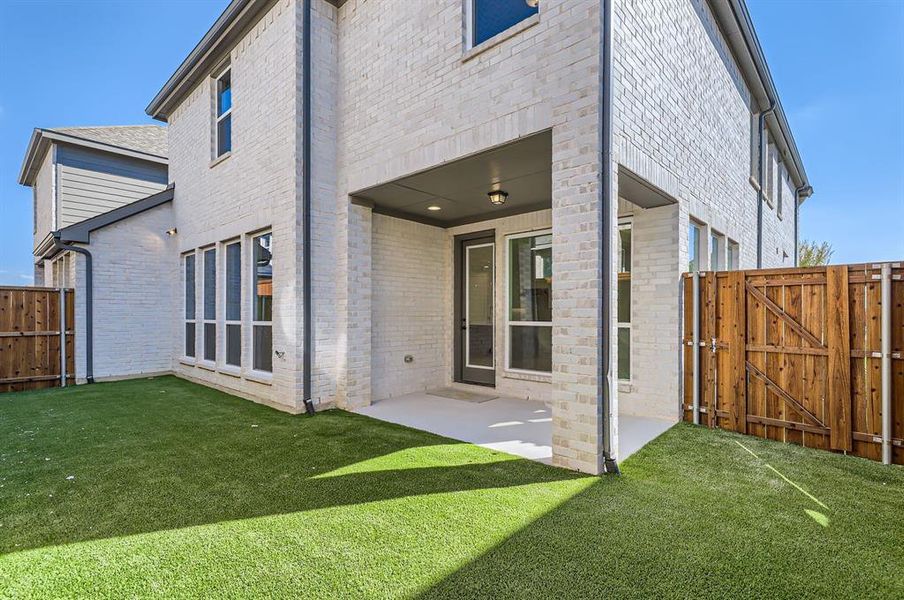 Back of house featuring a patio and a lawn