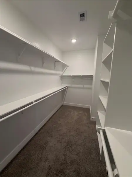 A dream walk-in closet with tons of space & built-in shelving!