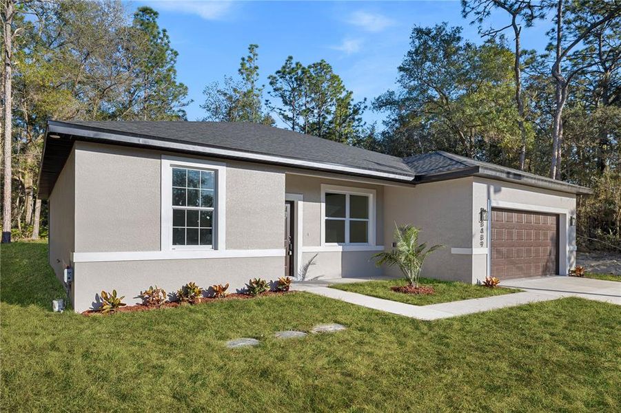 Front exterior of a new home in , Dunnellon, FL, highlighting curb appeal (Image 17).