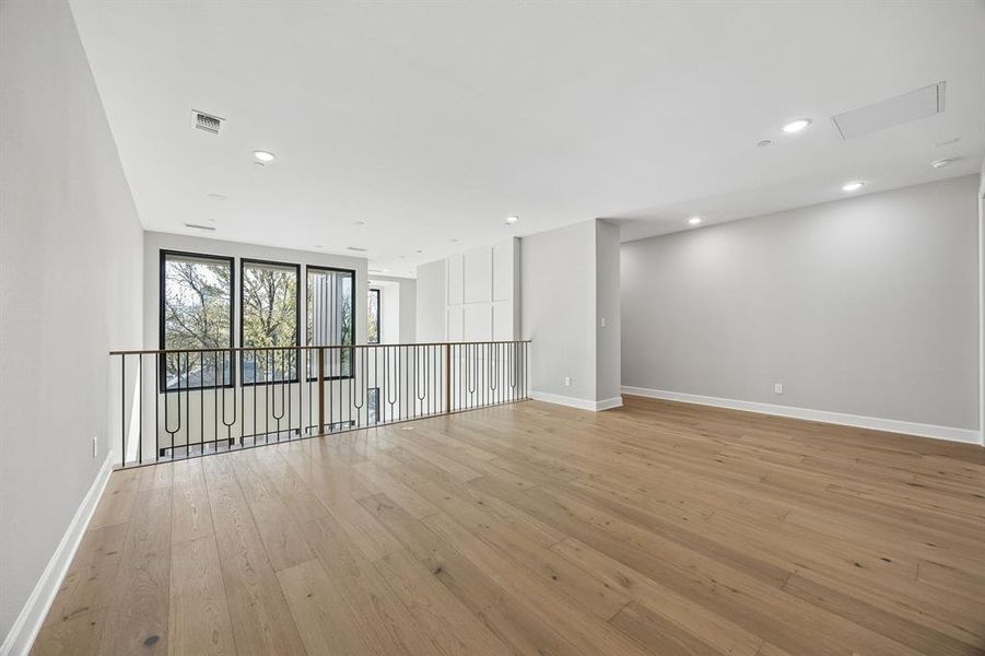 Spare room with light wood finished floors and recessed lighting Spare room with light wood finished floors and recessed lighting