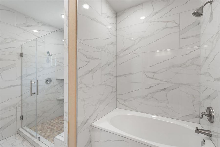 Separate oversized shower and tub in the primary bathroom