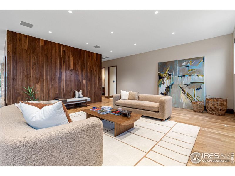 The family room also has artisan crafted trowel finish walls plus a beautiful walnut accent wall.  Inset walnut baseboards and wide plank white oak flooring.