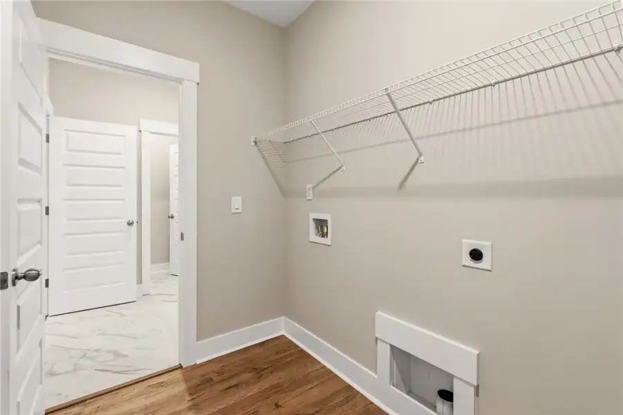 A dedicated laundry utility space features wire st A dedicated laundry utility space features wire st