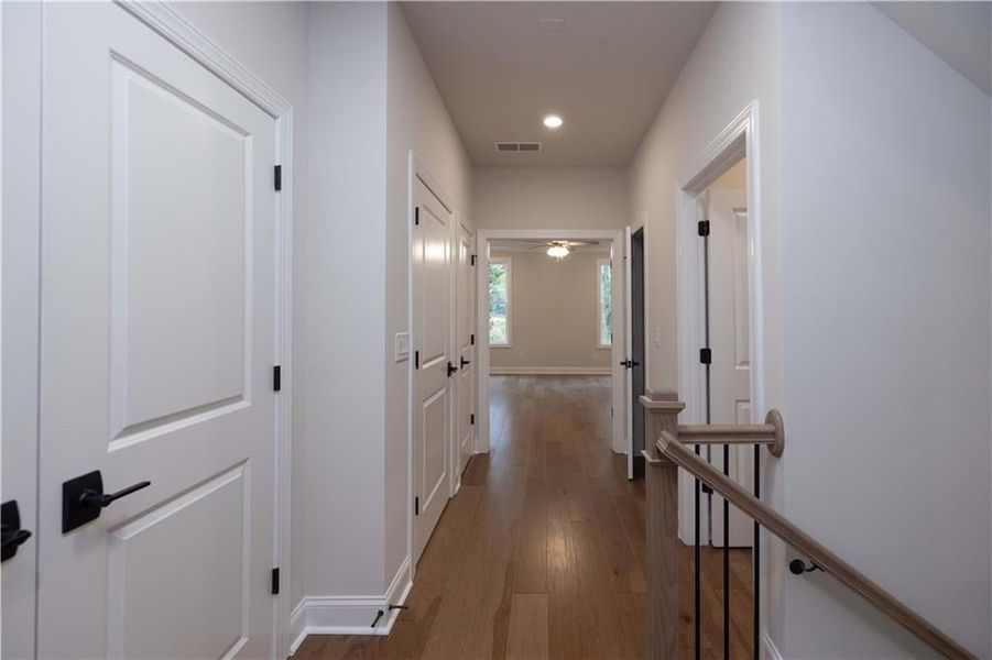 Hallway featuring dark wood-style flooring and recessed lighting