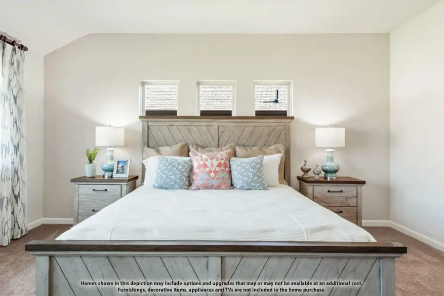 Bedroom with rustic wood bed frame, decorative pillows, matching nightstands, and carpet flooring