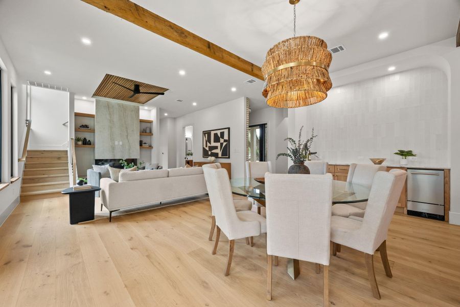 Gleaming hardwood floors and rustic wood beams define this open concept dining space.