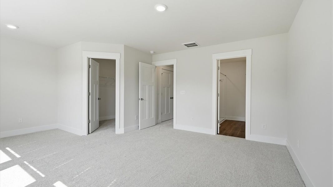 Exclusive upstairs retreat with a bright and airy primary suite with a walk-in closet Exclusive upstairs retreat with a bright and airy primary suite with a walk-in closet
