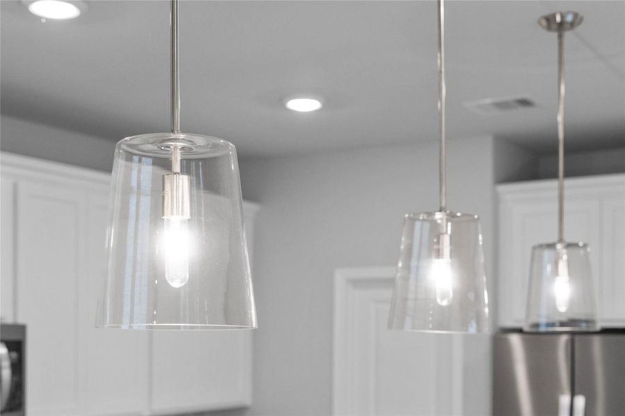 Clarion Pendant Brushed Nickel lights that hang over the kitchen island.
