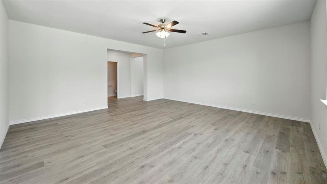Spare room with light wood-type flooring and ceiling fan