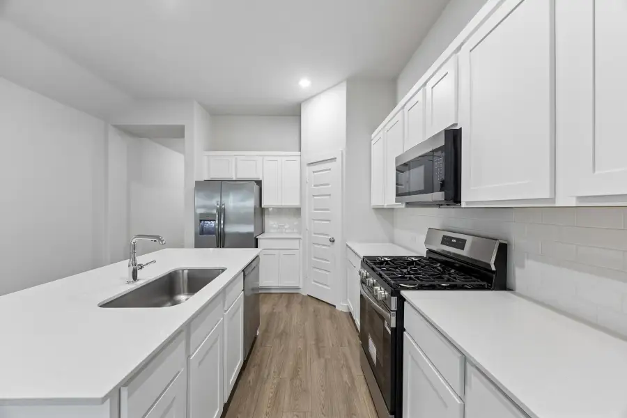 Kitchen in the Cedar home plan by Trophy Signature Homes – REPRESENTATIVE PHOTO Kitchen in the Cedar home plan by Trophy Signature Homes – REPRESENTATIVE PHOTO