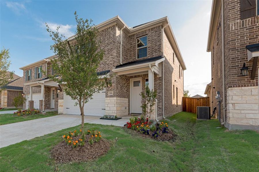 Front exterior of a new home in Walden Pond, Forney, TX, highlighting curb appeal (Image 19). Front exterior of a new home in Walden Pond, Forney, TX, highlighting curb appeal (Image 19).