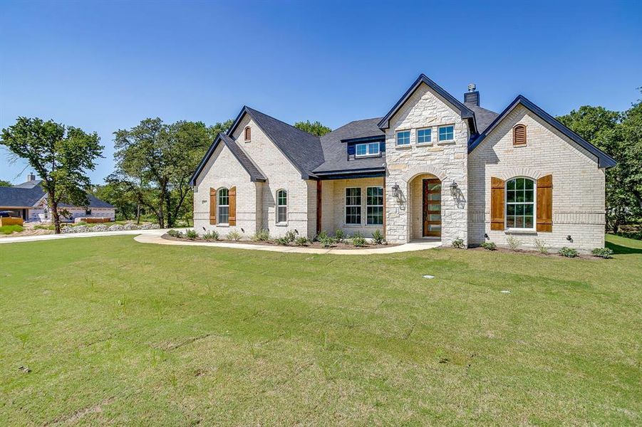 Front exterior of a new home in Escondido Ranches, Poolville, TX, highlighting curb appeal (Image 22). Front exterior of a new home in Escondido Ranches, Poolville, TX, highlighting curb appeal (Image 22).