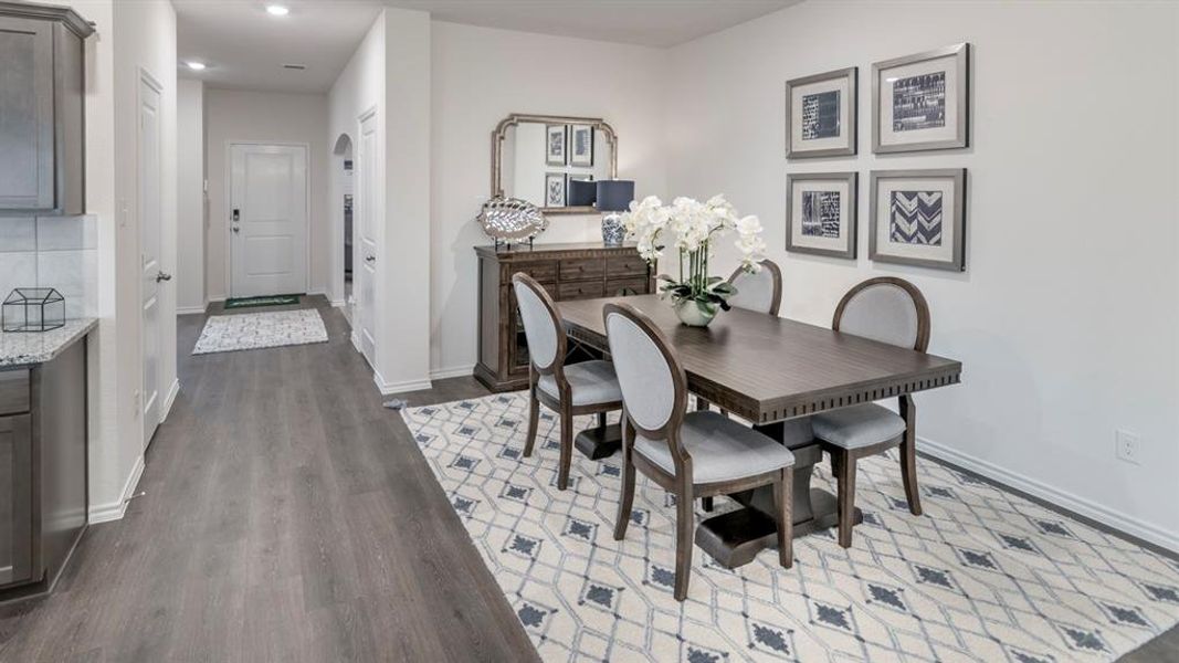 Dining area featuring dark wood finished floors and recessed lighting