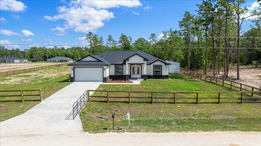 Front exterior of a new home in , Dunnellon, FL, highlighting curb appeal (Image 24). Front exterior of a new home in , Dunnellon, FL, highlighting curb appeal (Image 24).