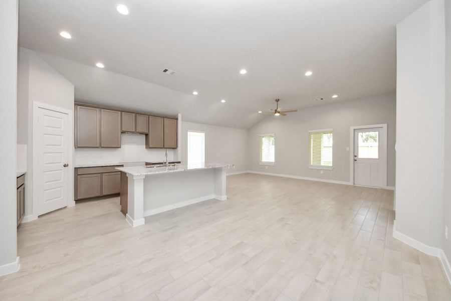 Make memories gathered around the table with your family and friends! This spacious dining room features elegant flooring, custom paint, and adjacent to family room and kitchen for open concept feel. Sample photo of completed home with similar floor plan. Actual colors and selections may vary.