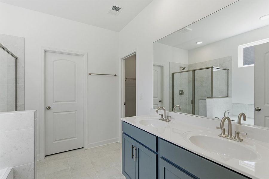 A bathroom with a large mirror. A bathroom with a large mirror.