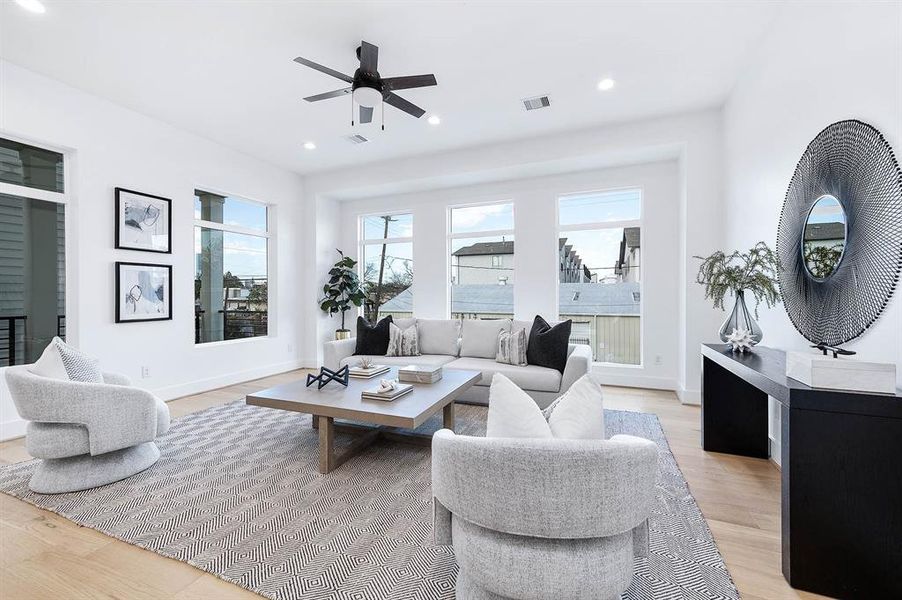 Large living area with tons of windows and lighting.