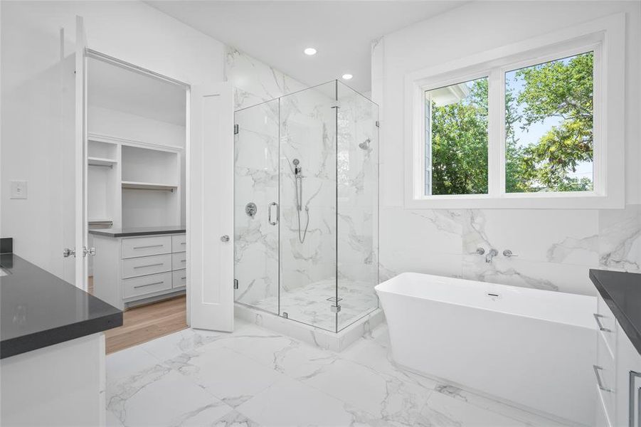 Another look at the primary bathroom leading into the closet. A small detail that I appreciate is the fact that the shower controls are at the entrance of the shower.