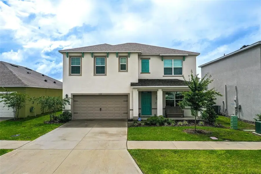 Front exterior of a new home in Harmony at Lake Eloise, Winter Haven, FL, highlighting curb appeal (Image 1). Front exterior of a new home in Harmony at Lake Eloise, Winter Haven, FL, highlighting curb appeal (Image 1).