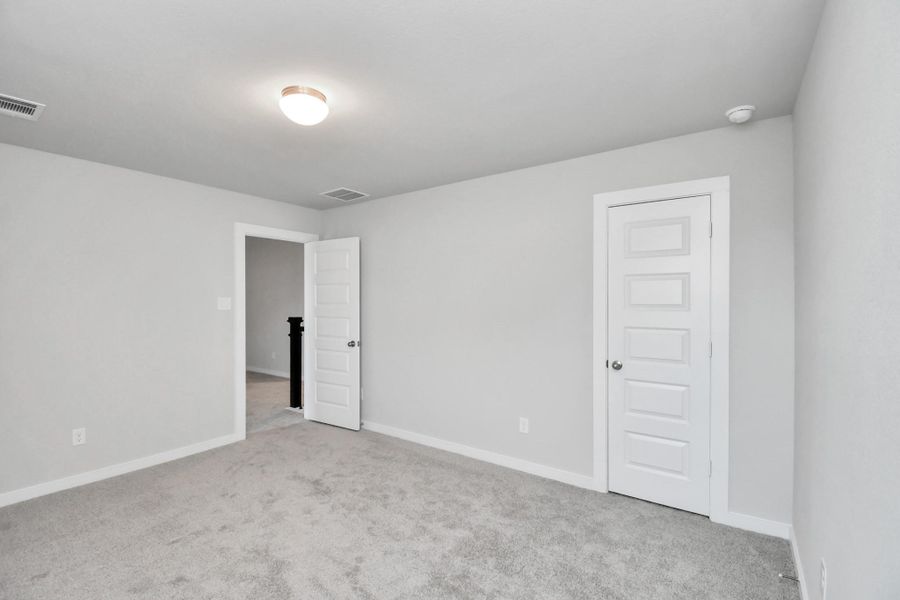 Generously sized secondary bedrooms featuring spacious closets, soft and inviting carpeting underfoot, large windows allowing plenty of natural light, and the added touch of privacy blinds for your personal retreat.