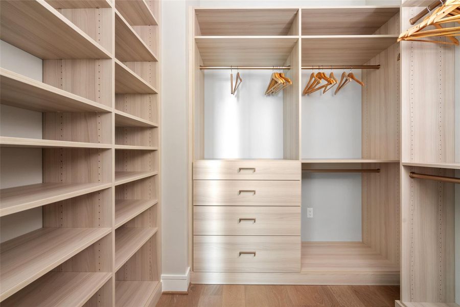 Primary bedroom features three primary walk in closets.