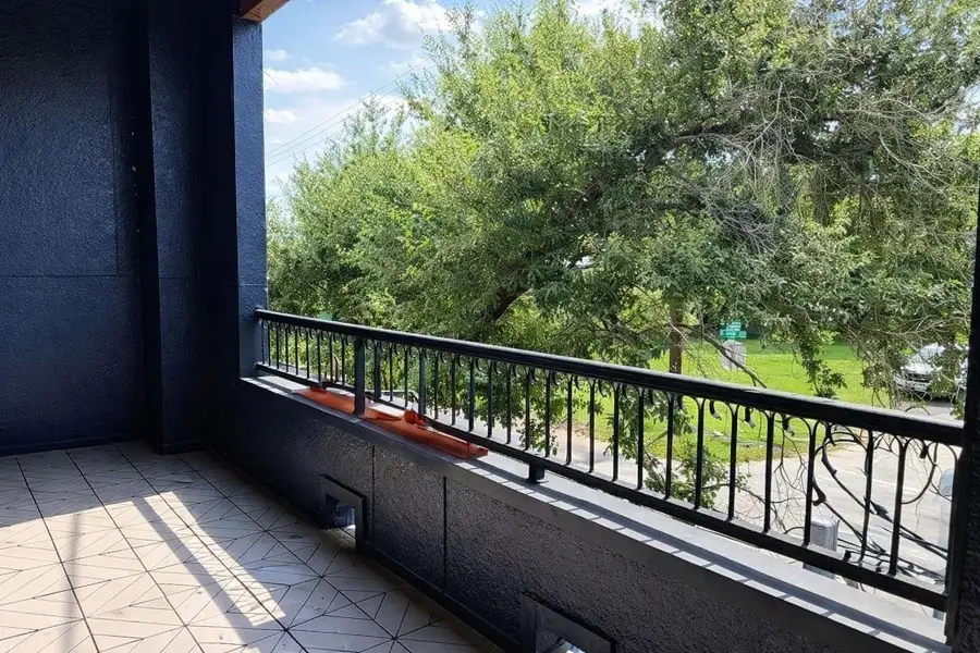 Huge covered balcony!  So nice to see green out your windows in the city and have a barrier from the Texas sun!