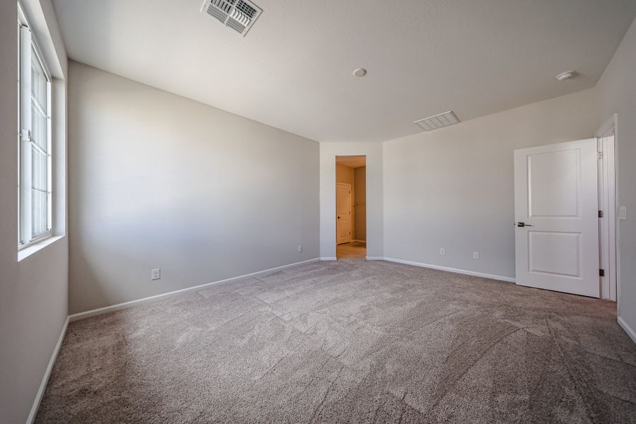 A room with a carpet and a door.