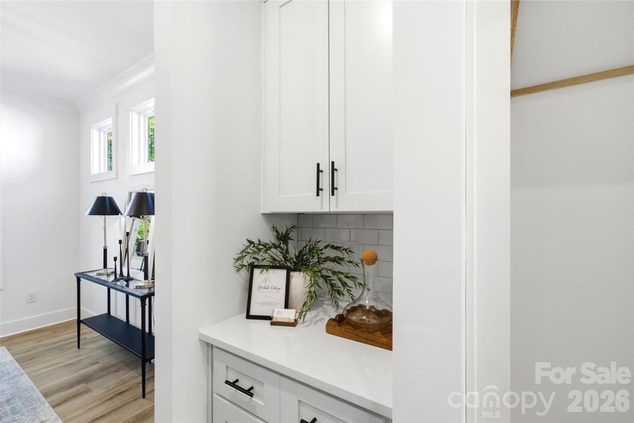 Butler’s pantry with upper and lower cabinetry, ideal for entertaining, prep space, and hidden storage