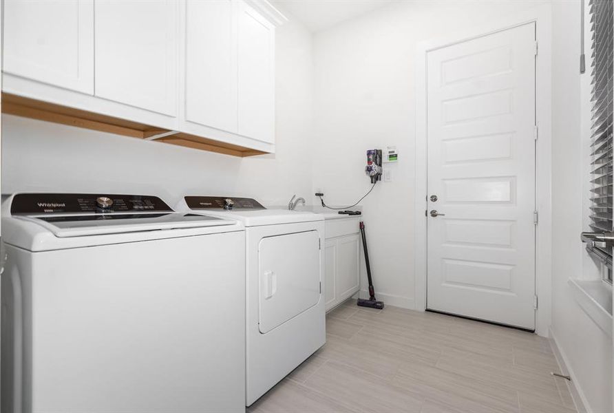 Laundry area featuring cabinet space and washer and clothes dryer Laundry area featuring cabinet space and washer and clothes dryer
