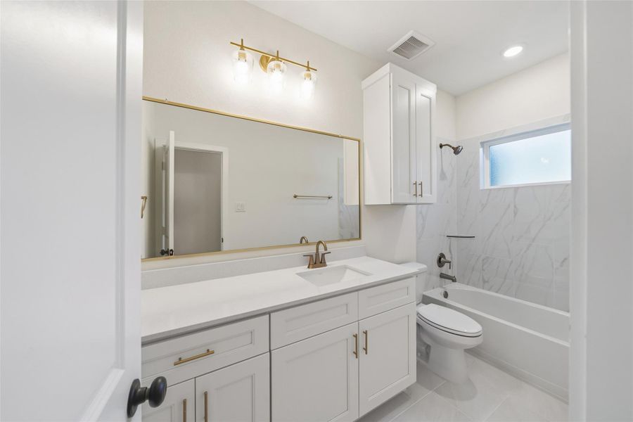 Full secondary bath with a tub for the pets and littles.