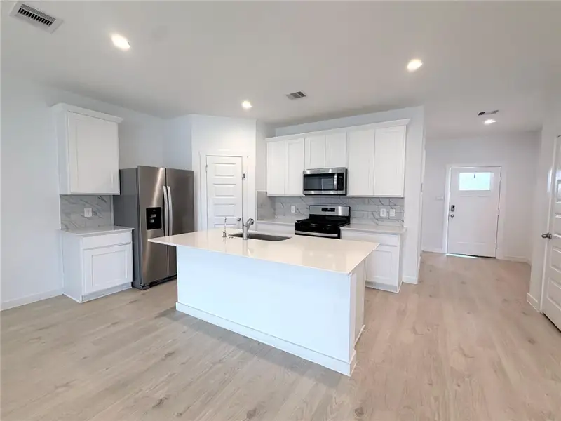 Beautiful white kitchen with ss appliances