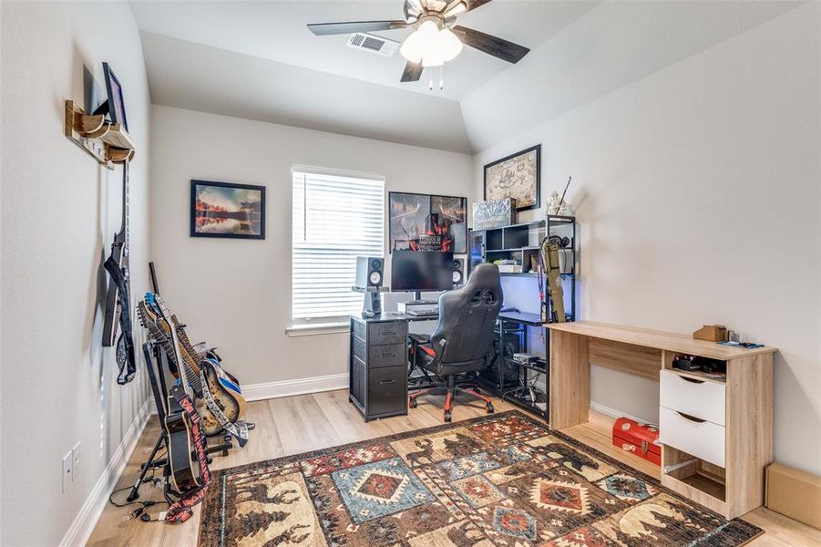 Office area with light wood-style floors and a ceiling fan Office area with light wood-style floors and a ceiling fan