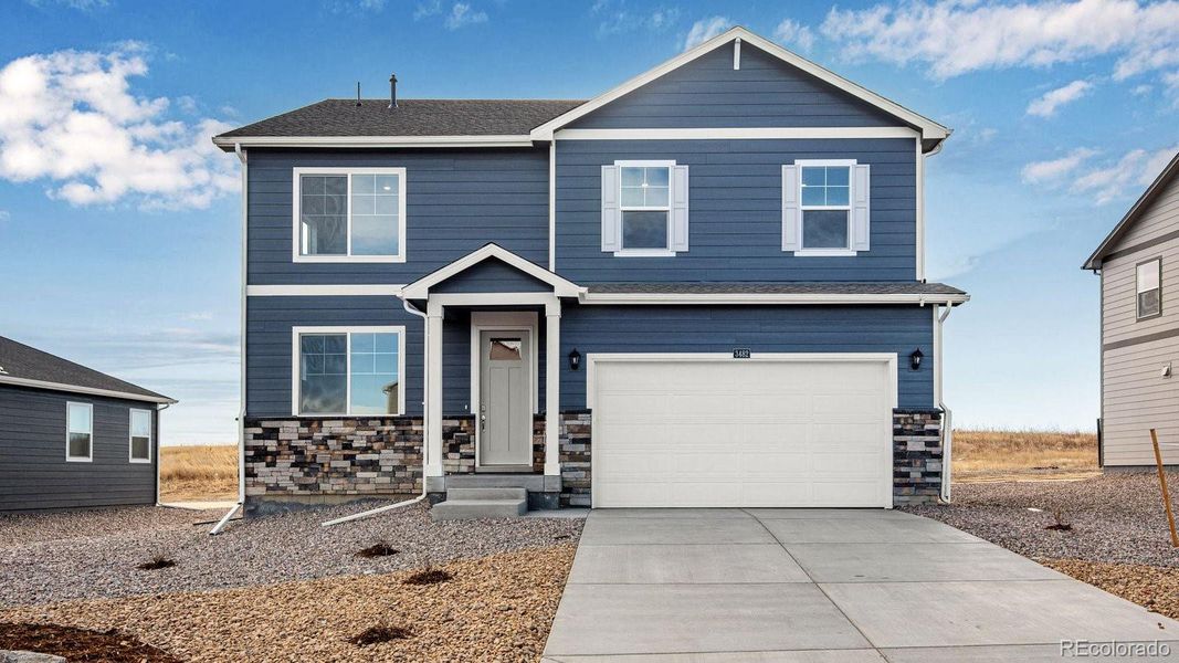 Front exterior of a new home in Silver Peaks, Lochbuie, CO, highlighting curb appeal (Image 1). Front exterior of a new home in Silver Peaks, Lochbuie, CO, highlighting curb appeal (Image 1).