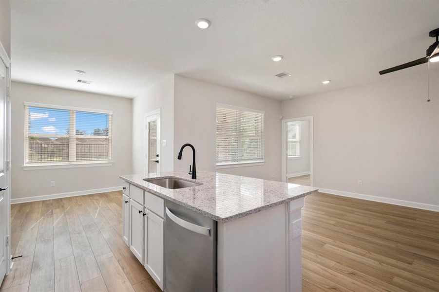 The living and dining room open into the kitchen to create one large, cohesive space to keep the family together during different activities.