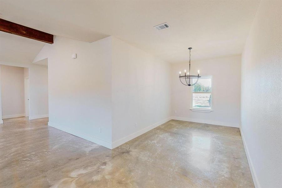 Unfurnished room with vaulted ceiling with beams and a chandelier