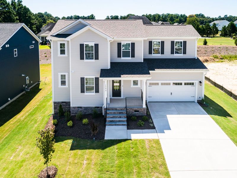 Front exterior of a new home in High Grove Oaks, Fuquay Varina, NC, highlighting curb appeal (Image 21). Front exterior of a new home in High Grove Oaks, Fuquay Varina, NC, highlighting curb appeal (Image 21).