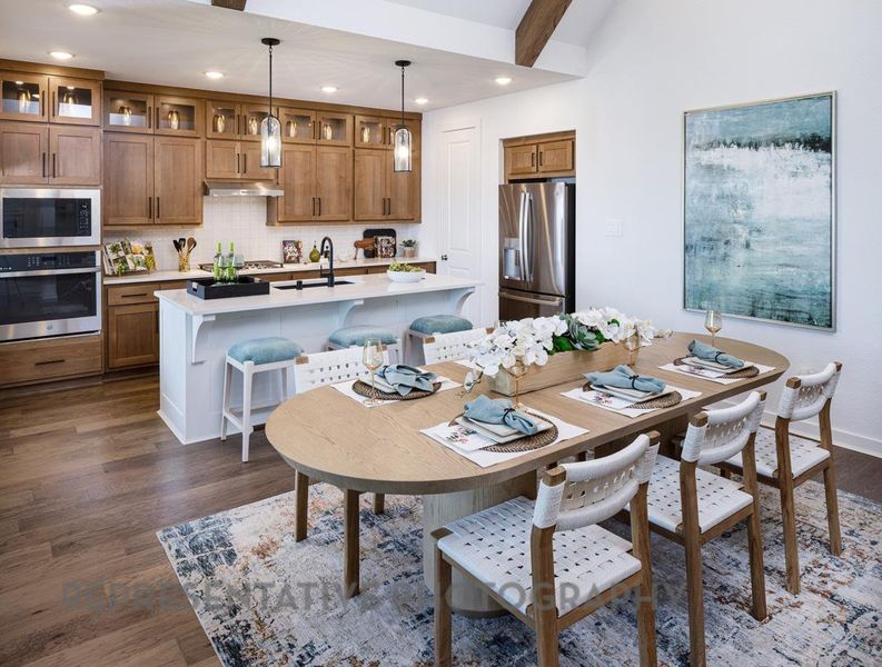 Dining area with dark wood-style flooring and recessed lighting