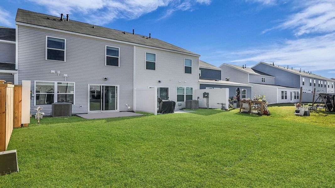 Exterior details and patio area of a home in Pine Hills Townhomes at Cane Bay, Summerville (Image 23).