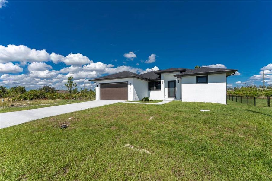 Front exterior of a new home in , Port Charlotte, FL, highlighting curb appeal (Image 1).