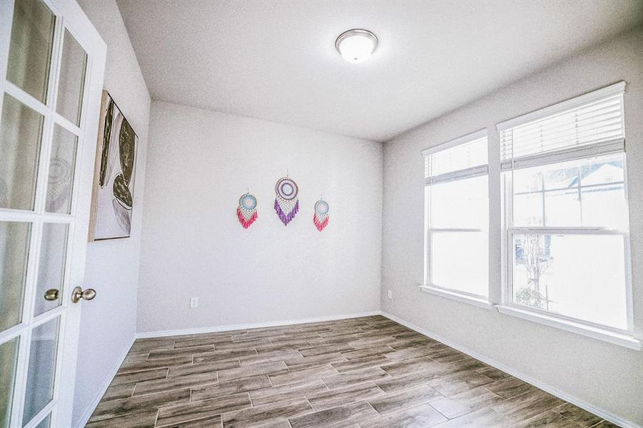 Unfurnished room with a wealth of natural light and french doors