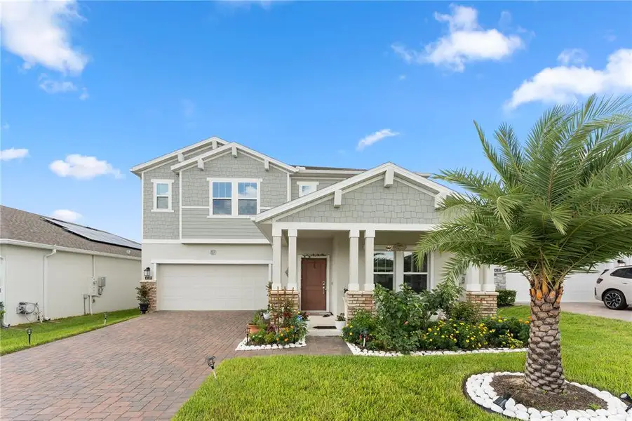 Front exterior of a new home in Golden Orchard, Apopka, FL, highlighting curb appeal (Image 1). Front exterior of a new home in Golden Orchard, Apopka, FL, highlighting curb appeal (Image 1).