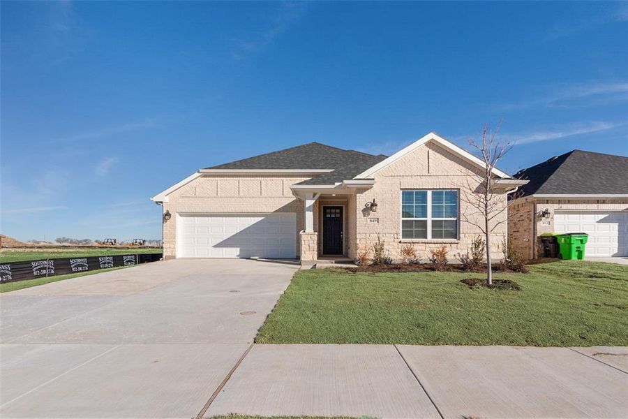 Front exterior of a new home in Wildflower Ranch, Justin, TX, highlighting curb appeal (Image 23).