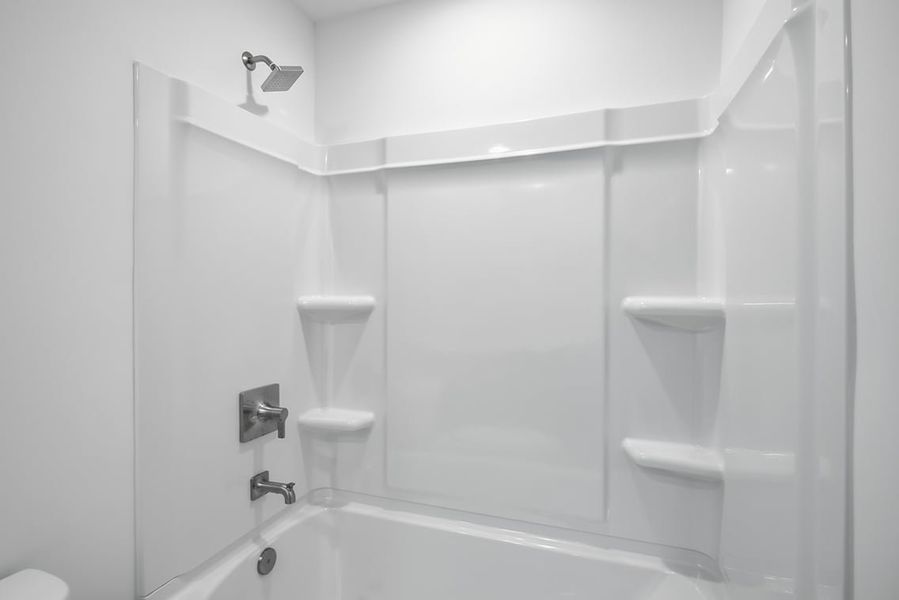 A bathroom with a glass shower. A bathroom with a glass shower.