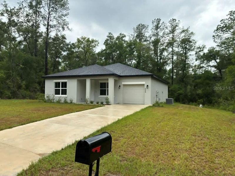 Front exterior of a new home in , Citrus Springs, FL, highlighting curb appeal (Image 10).