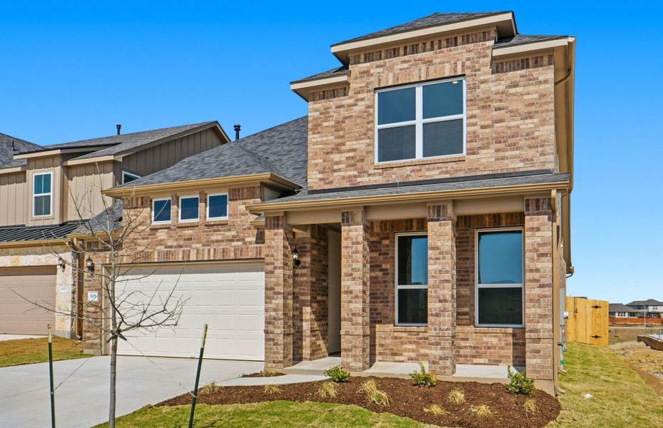 Front exterior of a new home in Sunfield, Buda, TX, highlighting curb appeal (Image 23).