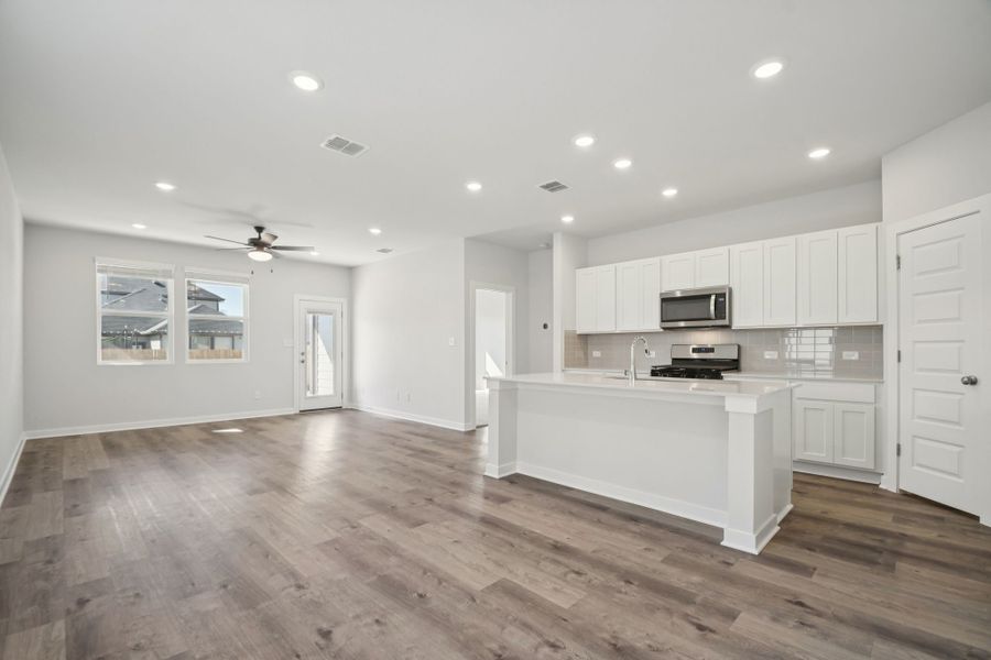 A kitchen with white cabinets.