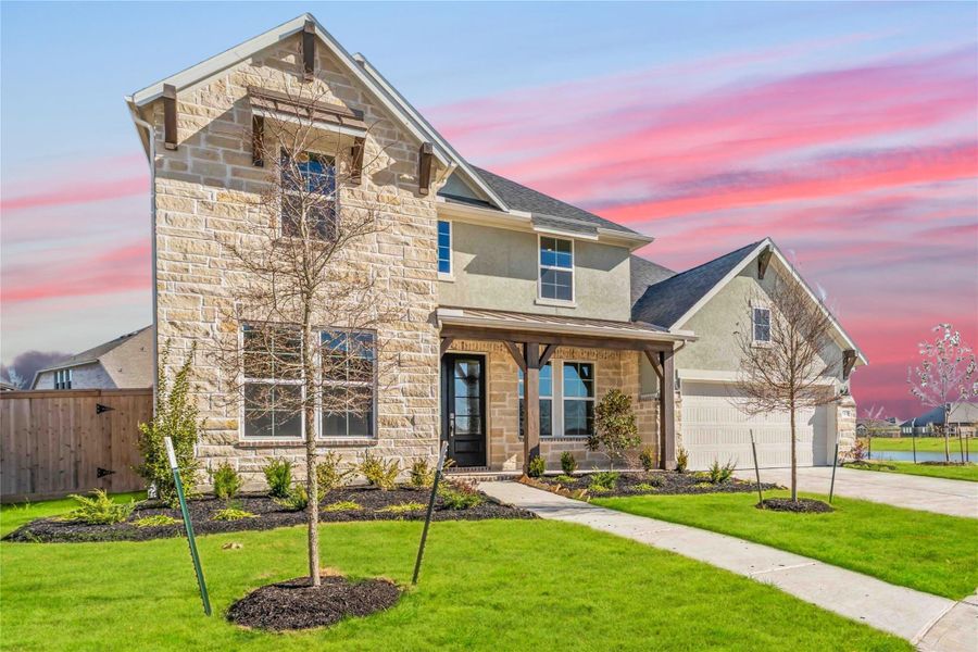 Front exterior of a new home in Valencia, Manvel, TX, highlighting curb appeal (Image 2).
