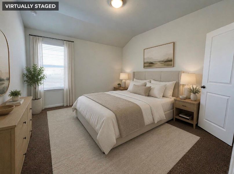 Upstairs bedroom. A well-lit bedroom features a vaulted ceiling, providing an airy and open atmosphere.