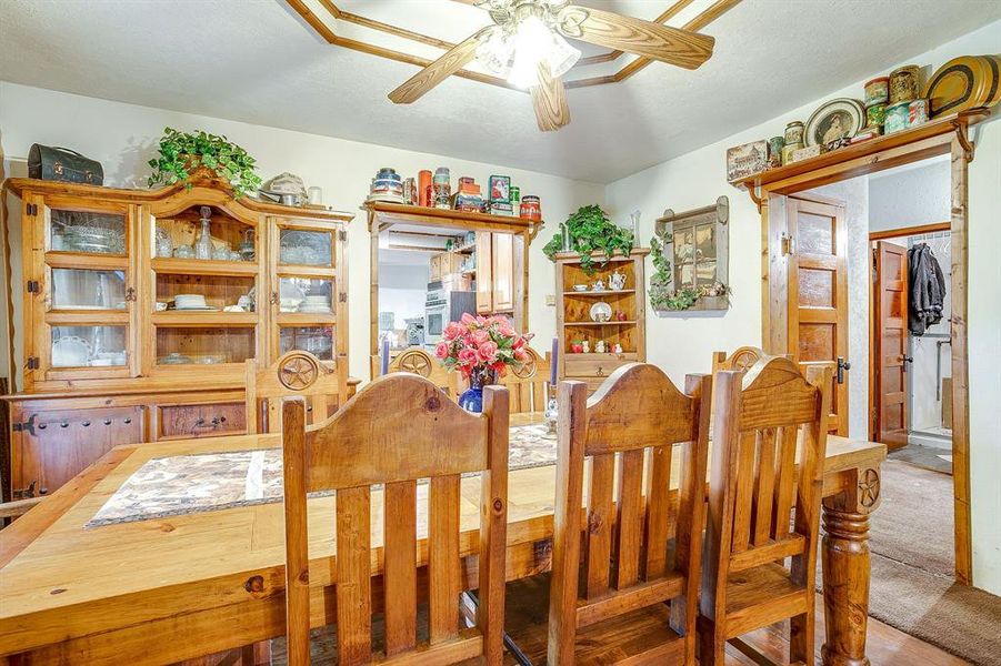 Dining area featuring ceiling fan and a textured ceiling Dining area featuring ceiling fan and a textured ceiling