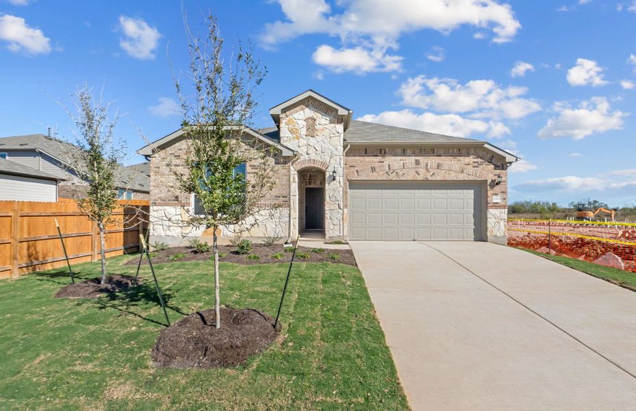Front exterior of a new home in Lagos, Manor, TX, highlighting curb appeal (Image 19).